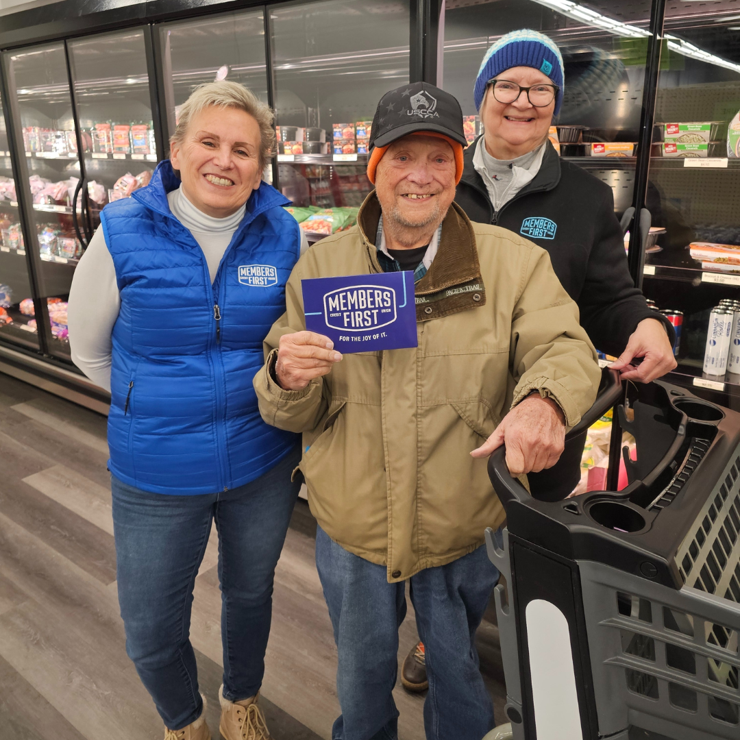 Team Members Give Gift Card at local store
